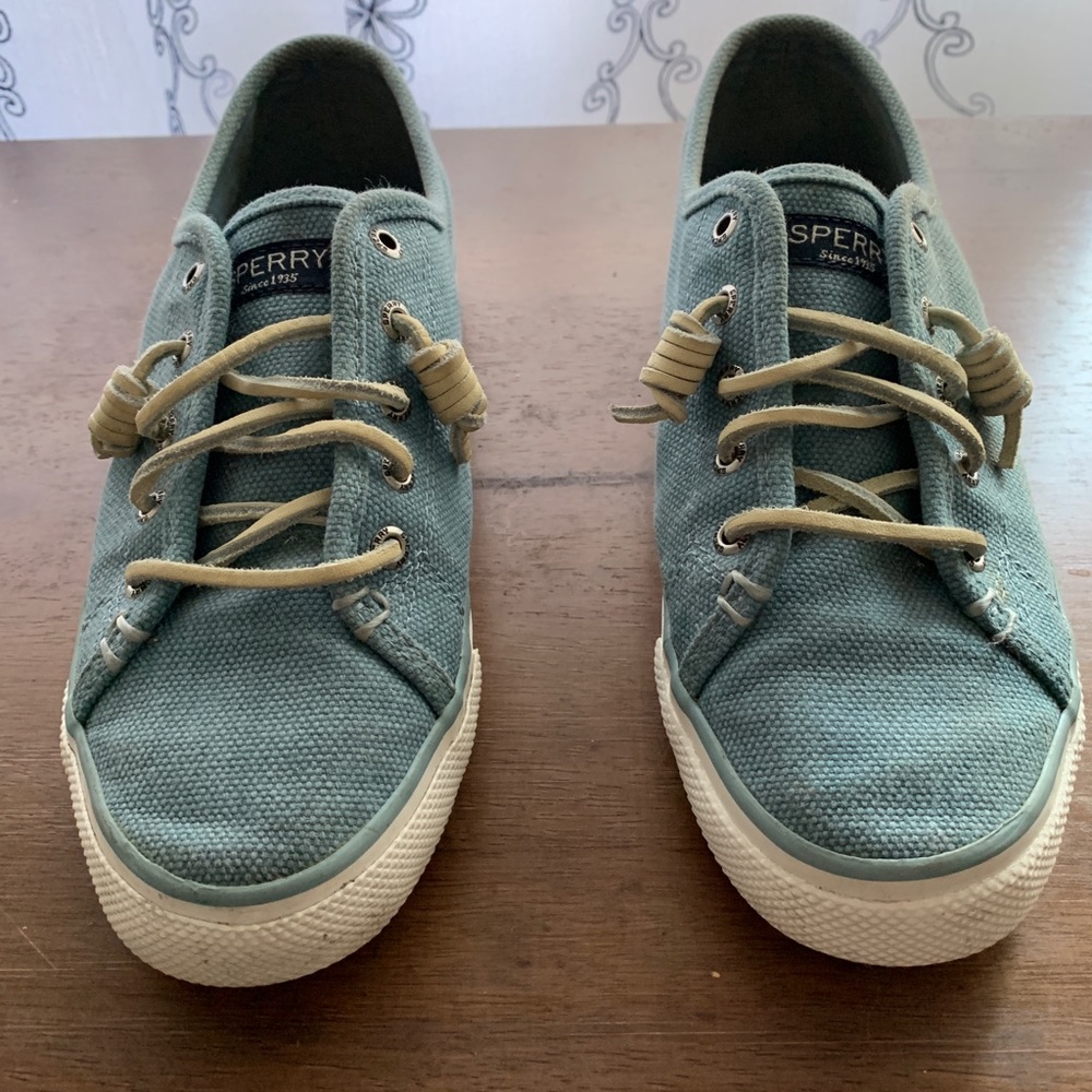 Light blue canvas slip-on Sperry sneakers. Off white leather laces. Size 7 1/2.